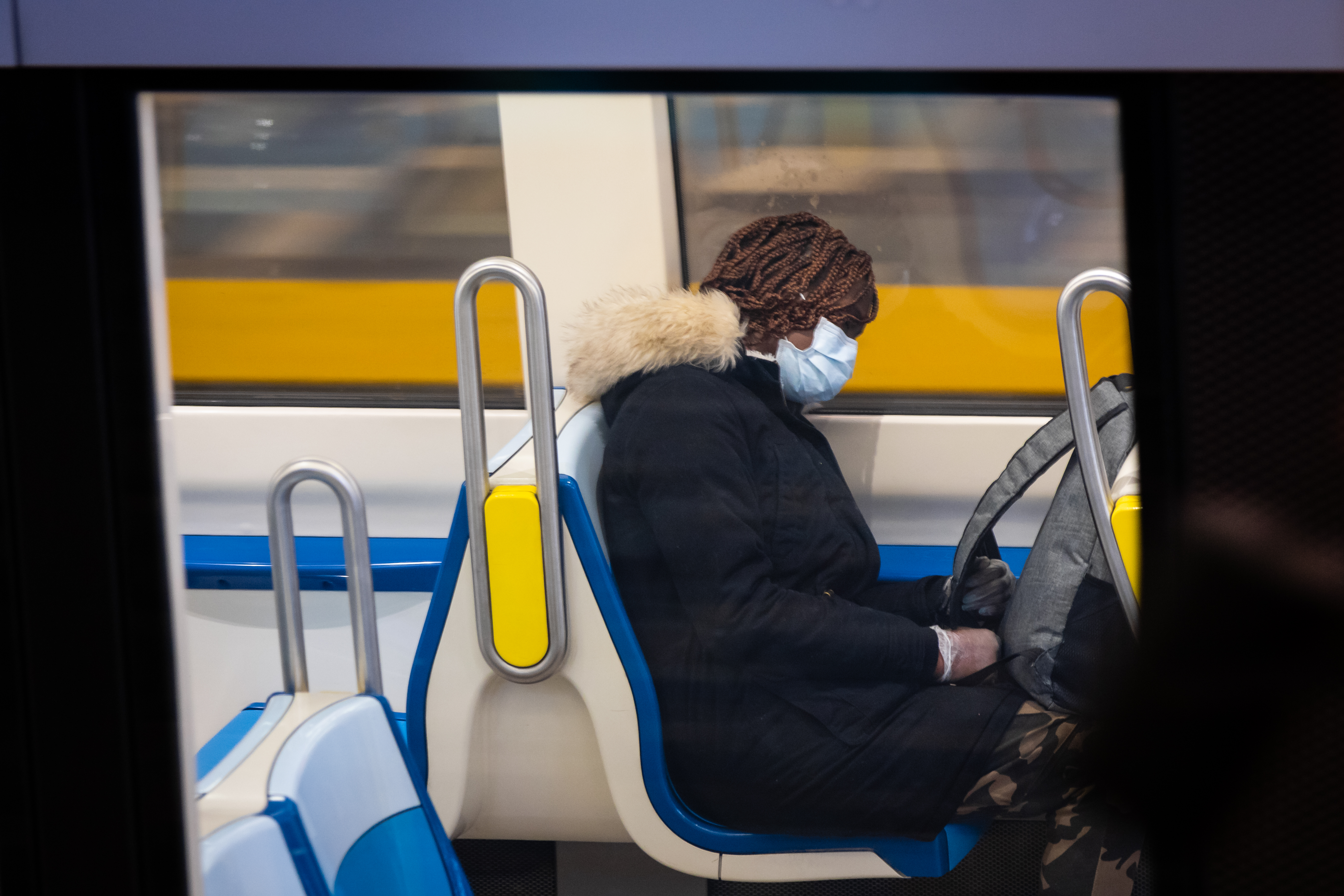 Une dame porte un masque dans le métro.